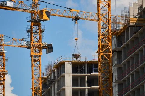 Construction Workers on Concrete Rooftop Handling Heavy Formwork Photos