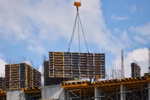 Construction Workers on Concrete Rooftop Handling Heavy Formwork Photos