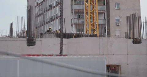 Construction workers on concrete structure with crane 스톡 동영상 332512673