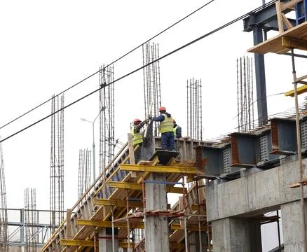 A construction workers on construction site and sky background. Russia, 2022 Stock Photos