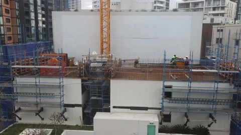 Construction workers at construction site building high-rise house as timelapse. Stock Footage 137441478