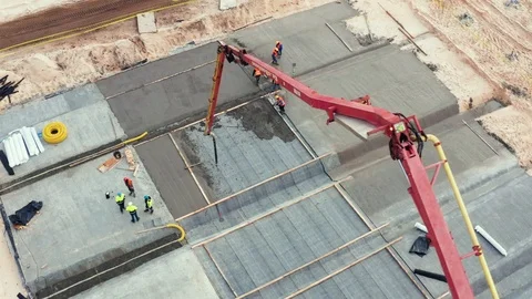 Construction workers on a construction site filling forms with cement aerial. Stock Footage 97221352