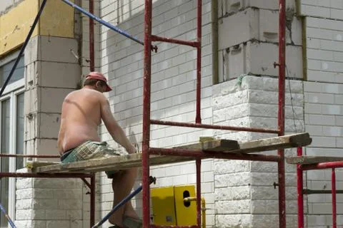 Construction workers at a construction site when the building insulation Stock Photos