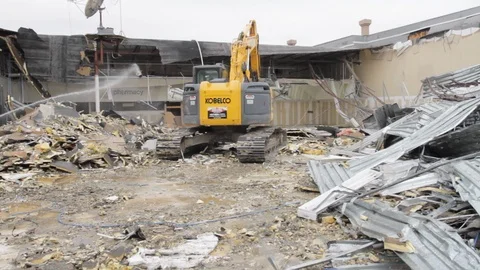 Construction workers control heavy machinery on demolition site A 스톡 동영상 125056453