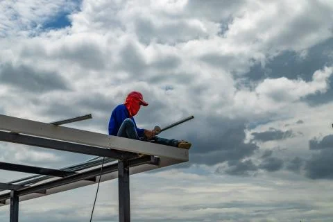 Construction workers cutting steel. Stock Photos