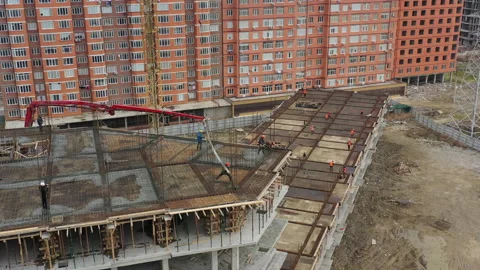 Construction workers deliver liquid concrete to upper floor Stock Footage 144327469
