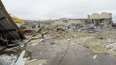 Construction workers at demolition site working heavy machinery A Stock Footage 125056466