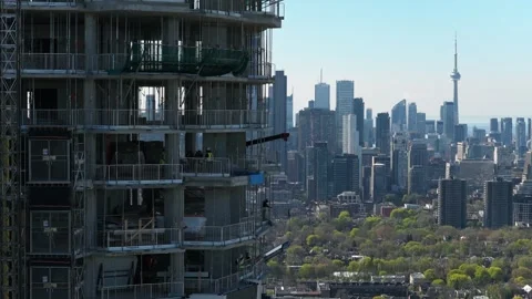 Construction workers developing residential building in midtown Toronto with CN Stock Footage 334695892