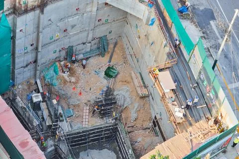 Construction workers developing urban infrastructure at building site Stock Photos
