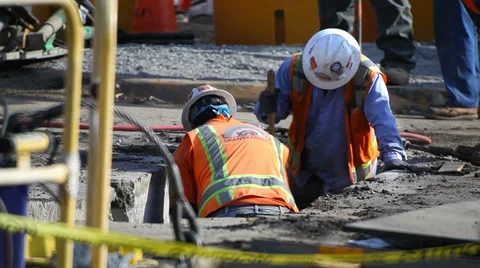 Construction workers dig communication trench at construction site Vídeo Stock 34574532