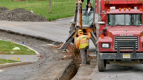 Construction workers digging pipe line Stock Footage 106365048