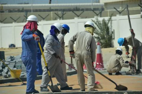 Construction workers digging trench using shovels. Abu Dhabi,UAE.03.10.2020. Stock Photos