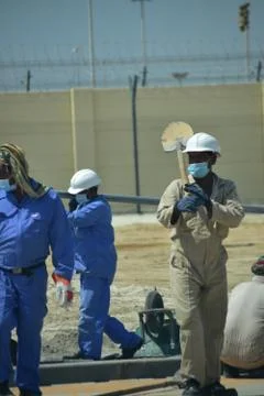 Construction workers digging trench using shovels. Abu Dhabi,UAE.03.10.2020. Stock Photos