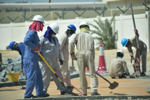 Construction workers digging trench using shovels. Abu Dhabi,UAE.03.10.2020. Stock Photos