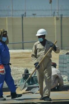 Construction workers digging trench using shovels. Abu Dhabi,UAE.03.10.2020. Stock Photos