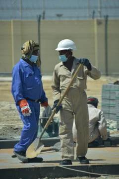 Construction workers digging trench using shovels. Abu Dhabi,UAE.03.10.2020. Stock Photos