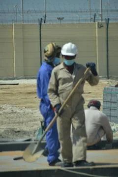 Construction workers digging trench using shovels. Abu Dhabi,UAE.03.10.2020. Stock Photos