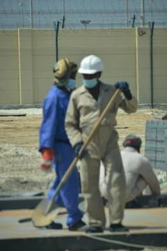 Construction workers digging trench using shovels. Abu Dhabi,UAE.03.10.2020. Stock Photos