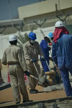 Construction workers digging trench using shovels. Abu Dhabi,UAE.03.10.2020. Stock Photos