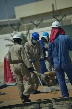 Construction workers digging trench using shovels. Abu Dhabi,UAE.03.10.2020. Stock Photos