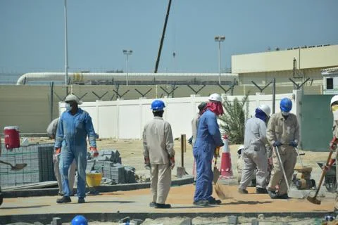 Construction workers digging trench using shovels. Abu Dhabi,UAE.03.10.2020. Stock Photos