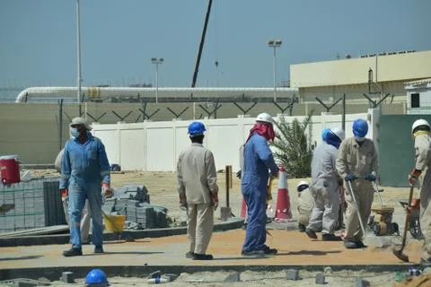 Construction workers digging trench using shovels. Abu Dhabi,UAE.03.10.2020. Stock Photos
