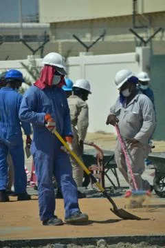 Construction workers digging trench using shovels. Abu Dhabi,UAE.03.10.2020. Stock Photos
