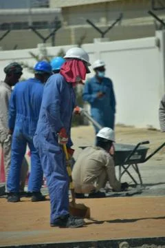 Construction workers digging trench using shovels. Abu Dhabi,UAE.03.10.2020. Stock Photos