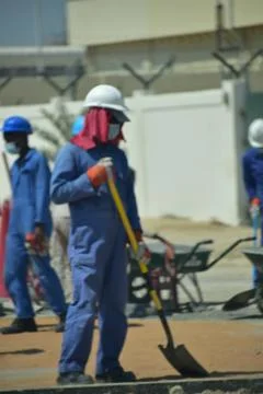 Construction workers digging trench using shovels. Abu Dhabi,UAE.03.10.2020. Stock Photos