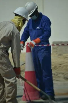 Construction workers digging trench using shovels. Abu Dhabi,UAE.03.10.2020. Stock Photos