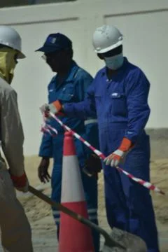 Construction workers digging trench using shovels. Abu Dhabi,UAE.03.10.2020. Stock Photos