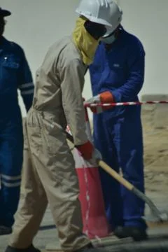 Construction workers digging trench using shovels. Abu Dhabi,UAE.03.10.2020. Stock Photos