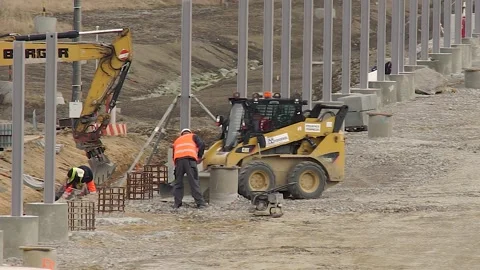 Construction Workers Ding Road Work and an Excavator Stock Footage 150499957