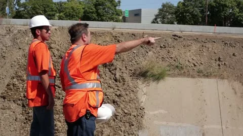Construction workers discuss work on irrigation ditch Stock Footage 11809188