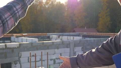 Construction workers discussing and measuring distance on site Stock Footage 315441576