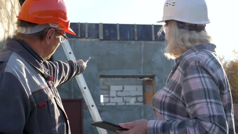 Construction workers discussing project plans on building site Stock Footage 315409964