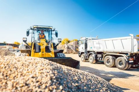 Construction workers doing earthworks with wheel loader Stock Photos