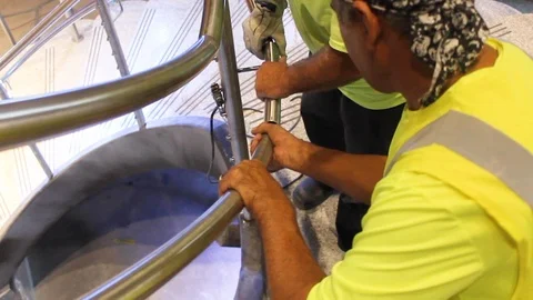 Construction workers doing metal work on stair steps on building site A Stock Footage 125057121