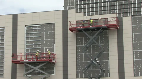 Construction workers on elevated platforms. Stock Footage 52127655