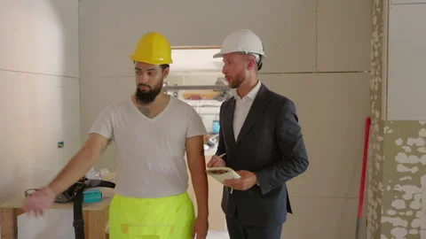 Construction Workers Engaged in a Collaborative and Detailed Site Inspection Stock Footage 308186258