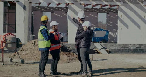 Construction workers with engineer and architect discussing together Stock Footage 187037718