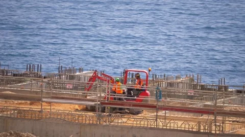 Construction workers with excavator at seaside building site in 4K Stock Footage 316582165