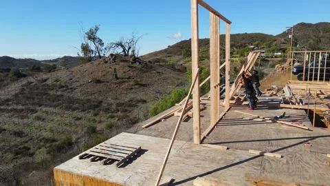 Construction workers framing a house with a view Stock-Footage 228794855