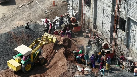 Construction Workers Gathering Material at Industrial Building Site with Stock Footage 344230142