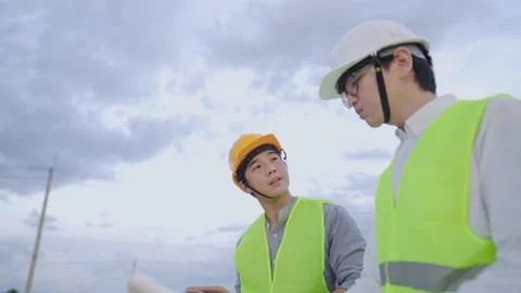 Construction workers get together talking at outdoor construction site Stock Footage 156886016