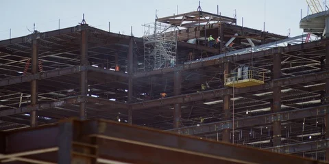 Construction Workers Grind and Weld Steel for Skyscraper Stock Footage