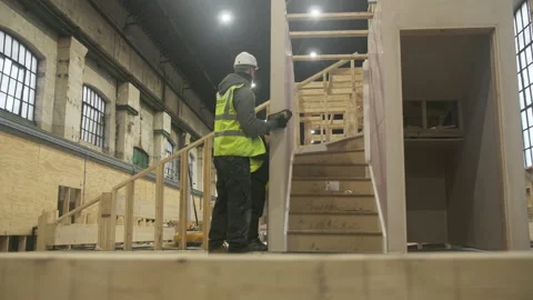 Construction workers guiding prefab staircase lifted by crane, UK Stock-Footage 155057273