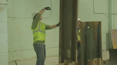 Construction Workers Guiding Steel Beam On Construction Site 4 Stock Footage 46580087