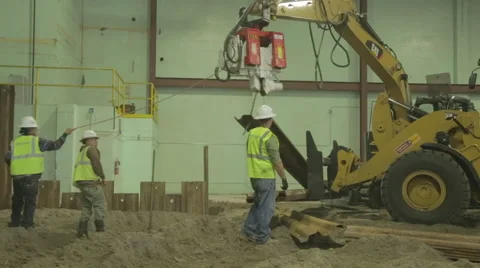 Construction Workers Guiding Steel Beam On Construction Site 2 Stock Footage 46587654