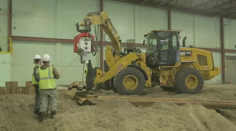 Construction Workers Guiding Yellow Loader On Construction Site 2 Stock Footage 46590778